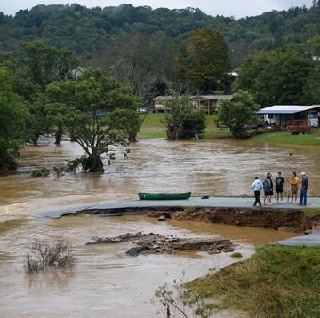 boone, north carolina september 27 friends talk after having canoed the flooded south fork new river for 32 minutes and landing at a washed out road on september 27, 2024 in boone, north carolina we saw trailers floating by, and cars toppled over, said one of the friends rains from what was hurricane helene have dropped more than a foot of rain across much of the region photo by melissa sue gerritsgetty imageses