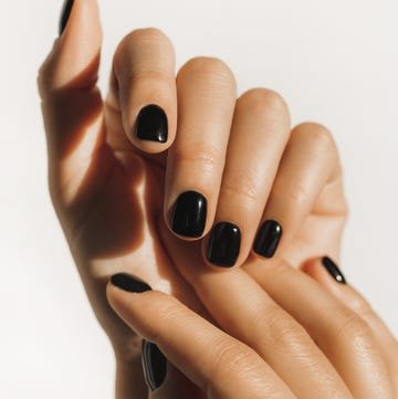 manicure on female hands with black nail polish